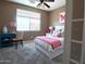 Charming bedroom with a cozy bed, bright desk, and soft color palette for a serene retreat at 6619 W Cordia Ln, Phoenix, AZ 85083