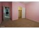 A carpeted bedroom features access to the closet and hall at 6619 W Cordia Ln, Phoenix, AZ 85083