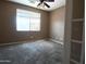Bedroom with neutral walls, carpet flooring, and natural light from a bright window at 6619 W Cordia Ln, Phoenix, AZ 85083