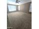 Comfortable bedroom with carpet, a ceiling fan, and multiple windows providing ample natural light at 6619 W Cordia Ln, Phoenix, AZ 85083
