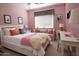 Charming pink bedroom featuring a comfortable window seat and a bright, inviting decor at 6619 W Cordia Ln, Phoenix, AZ 85083