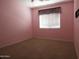 A carpeted bedroom features a ceiling fan and a window with blinds at 6619 W Cordia Ln, Phoenix, AZ 85083