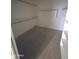 Organized walk-in closet with built-in shelving for efficient storage and organization at 6619 W Cordia Ln, Phoenix, AZ 85083