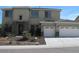 Two-story home featuring a two car garage, front yard with desert landscaping and neutral stucco and stone accents at 6619 W Cordia Ln, Phoenix, AZ 85083