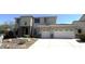 Two-story home featuring a three-car garage, stone accents, and well-maintained landscaping at 6619 W Cordia Ln, Phoenix, AZ 85083