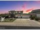 Stunning two-story home featuring a 3-car garage, desert landscaping, and a picturesque sunset backdrop at 6619 W Cordia Ln, Phoenix, AZ 85083