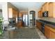 Gourmet kitchen featuring stainless steel appliances, granite countertops, and ample cabinet space at 6619 W Cordia Ln, Phoenix, AZ 85083