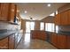Kitchen featuring stainless steel appliances, dark countertops, wood cabinets and backyard access at 6619 W Cordia Ln, Phoenix, AZ 85083