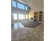 Bright living room featuring a fireplace, tile and carpet flooring, and large windows for natural light at 6619 W Cordia Ln, Phoenix, AZ 85083