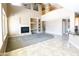 Spacious living room featuring a fireplace, built-in shelving, and large windows for natural light at 6619 W Cordia Ln, Phoenix, AZ 85083