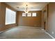Light-filled living room with neutral paint and a charming chandelier fixture at 6619 W Cordia Ln, Phoenix, AZ 85083