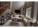 Comfortable living room featuring a cozy sofa, high ceilings, and a stylish staircase at 6619 W Cordia Ln, Phoenix, AZ 85083