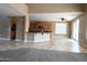Open-concept living space showcasing tile flooring, a kitchen view, and natural light from sliding glass doors at 6619 W Cordia Ln, Phoenix, AZ 85083