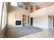 Open living area with a fireplace, built-in shelving, and a view of the second-floor balcony at 6619 W Cordia Ln, Phoenix, AZ 85083