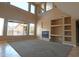 Spacious living room with a fireplace, built-in shelving, and large windows offering ample natural light at 6619 W Cordia Ln, Phoenix, AZ 85083
