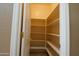 Walk-in pantry with multiple shelves for ample storage space and white walls at 6619 W Cordia Ln, Phoenix, AZ 85083