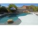 Beautiful backyard pool with rock waterfall feature and lush landscaping at 6619 W Cordia Ln, Phoenix, AZ 85083