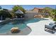 Beautiful backyard pool with lush landscaping and comfortable seating areas at 6619 W Cordia Ln, Phoenix, AZ 85083