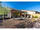 Expansive backyard featuring a covered patio, outdoor grill, and serene desert landscaping at 6929 E Quill St, Mesa, AZ 85207