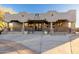 The clubhouse at Las Sendas with stucco exterior and covered entry with beautiful stone and wood railing accents at 6929 E Quill St, Mesa, AZ 85207