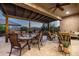Spacious covered patio area with dining table, comfortable seating perfect for outdoor entertaining at 6929 E Quill St, Mesa, AZ 85207