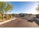 Paved entrance leading through gates to a residential community with well-maintained landscaping at 6929 E Quill St, Mesa, AZ 85207