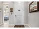 Bright entryway featuring a white door, tile floors, and views into the bedroom at 6929 E Quill St, Mesa, AZ 85207