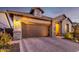 View of home featuring a brick driveway, a brown garage door, and stone veneer at 6929 E Quill St, Mesa, AZ 85207