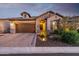 Charming home featuring stone accents, a brick driveway, and well-maintained landscaping at 6929 E Quill St, Mesa, AZ 85207