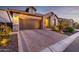 Beautiful home with a brick driveway, well-kept landscaping, and stone detailing at 6929 E Quill St, Mesa, AZ 85207