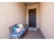 Front porch area, featuring a decorative wreath on the door, bench, and a welcome mat at 6929 E Quill St, Mesa, AZ 85207
