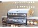 Close-up of a stainless steel grill with stone accents, perfect for outdoor cooking at 6929 E Quill St, Mesa, AZ 85207