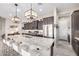 Elegant kitchen featuring pendant lighting, an island with seating, and stainless steel appliances at 6929 E Quill St, Mesa, AZ 85207