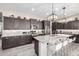 Spacious kitchen featuring granite countertops, dark cabinets, and stainless steel appliances at 6929 E Quill St, Mesa, AZ 85207