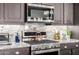 Modern kitchen features stainless steel appliances, granite countertops, and beautiful dark wood cabinetry at 6929 E Quill St, Mesa, AZ 85207