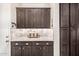 Stylish kitchen featuring granite counters and dark wood cabinets for a sleek, modern design at 6929 E Quill St, Mesa, AZ 85207