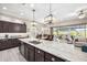 Open-concept kitchen with granite countertops, dark cabinetry, and a view into the backyard at 6929 E Quill St, Mesa, AZ 85207