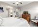 Tranquil main bedroom with ceiling fan, adjacent bathroom and a beautiful wood dresser at 6929 E Quill St, Mesa, AZ 85207