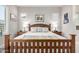 Cozy main bedroom with neutral walls, wood-look floors, and natural light creating a relaxing retreat at 6929 E Quill St, Mesa, AZ 85207