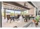Inviting covered patio with comfortable seating, dining area, and desert views perfect for relaxing and entertaining at 6929 E Quill St, Mesa, AZ 85207
