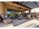 Inviting covered patio with comfortable seating and a ceiling fan for relaxing outdoors at 6929 E Quill St, Mesa, AZ 85207