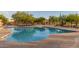 Large community pool surrounded by lounge chairs and shaded seating areas for resident relaxation at 6929 E Quill St, Mesa, AZ 85207