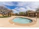 Inviting spa with desert landscaping and shaded lounge areas for relaxation and enjoying the beautiful scenery at 6929 E Quill St, Mesa, AZ 85207