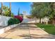 Spacious shuffleboard court surrounded by lush greenery, perfect for outdoor recreation and entertainment at 6941 W Voltaire Ave, Peoria, AZ 85381