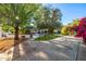 Expansive backyard featuring a pool, verdant landscaping, and a shuffleboard court for outdoor enjoyment at 6941 W Voltaire Ave, Peoria, AZ 85381