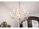 Elegant chandelier with crystal pendants hangs from an ornate ceiling medallion in this luxurious home at 6941 W Voltaire Ave, Peoria, AZ 85381