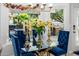 Bright dining area with blue chairs and a glass table, perfect for enjoying meals with natural light at 6941 W Voltaire Ave, Peoria, AZ 85381