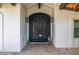 Elegant double doors with custom ironwork, enhanced by decorative lanterns at 6941 W Voltaire Ave, Peoria, AZ 85381
