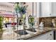 Close-up of a kitchen sink with granite countertops and stylish faucet, surrounded by decorative items at 6941 W Voltaire Ave, Peoria, AZ 85381