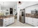 Open concept kitchen featuring stainless steel appliances, granite countertops, and tiled flooring at 6941 W Voltaire Ave, Peoria, AZ 85381
